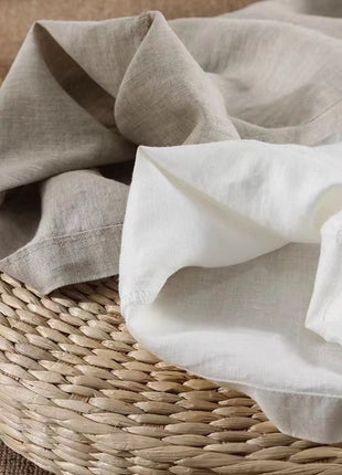 Folded beige and white fabric on a woven basket