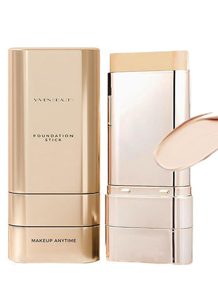 Gold foundation stick with packaging on a white background