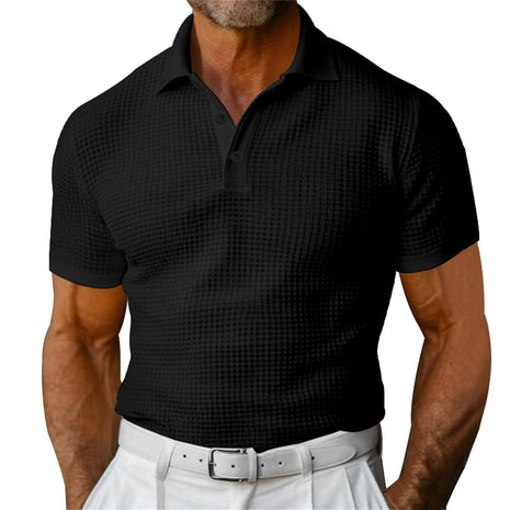 Black patterned polo shirt worn by a person on a white background