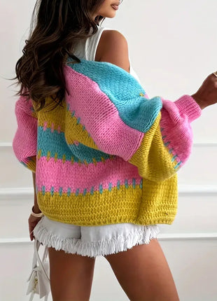 Person wearing a colorful sweater with pink, yellow, and blue patterns.