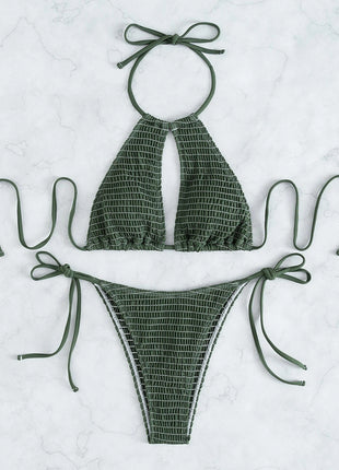 Green bikini set with halter top and tied sides on a light gray background