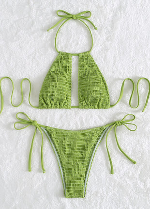 Green bikini set on a textured white background