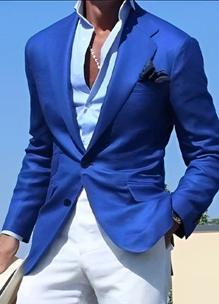Person wearing a blue blazer over a white shirt with a clear blue sky background
