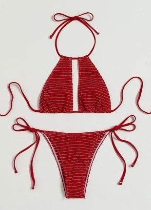 Red bikini set with halter top and tie sides on a light gray background