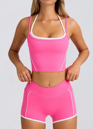 Woman wearing a pink athletic outfit with white accents on a light gray background