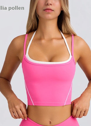 Woman wearing a pink sports bra and leggings on a light gray background