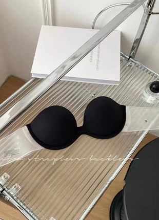 Black bra on a clear stand with a white background