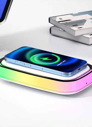Wireless charging pad with smartphone on a white surface