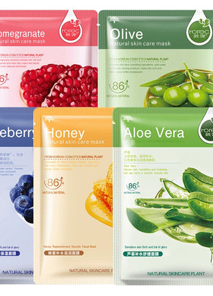 Five skin care mask packages with different ingredients on a white background