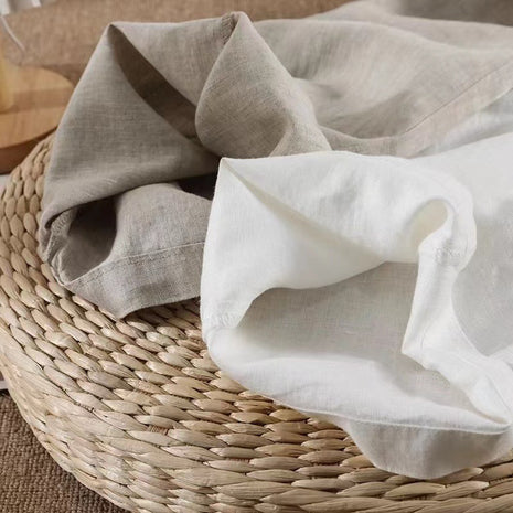 Folded beige and white fabric on a woven basket