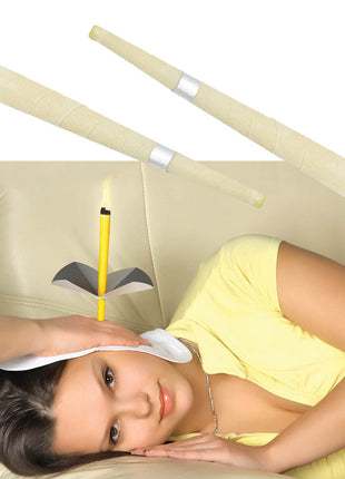 Woman lying on a couch with a headband and candles, possibly for relaxation or meditation.