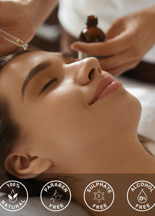 Woman receiving a facial treatment with a dropper and bottle, featuring icons for natural, paraben-free, sulfate-free, and alcohol-free products.