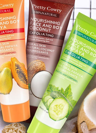 Three tubes of 'Pretty Cowry' facial and body exfoliating products with papaya, coconut, and cucumber imagery.