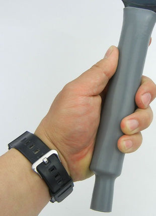 Hand holding a gray vacuum cleaner attachment against a white background