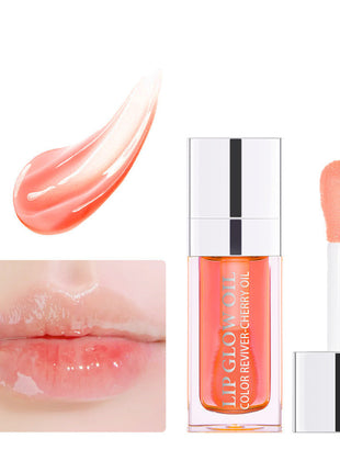 A collection of lip gloss lipsticks in various colors, displayed in clear tubes with silver caps, arranged on a white surface with lighting that creates reflections and highlights.