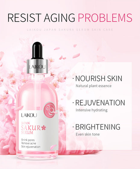 Laikou Sakura Serum bottle with cherry blossoms on a pink background