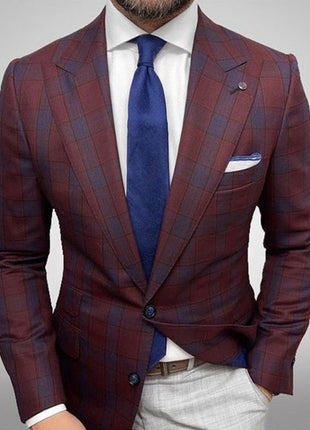 Maroon checkered suit with blue tie and white shirt on a gray background