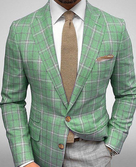 Green plaid suit with a brown tie on a gray background