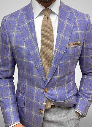 Blue plaid suit jacket with a brown tie and pocket square on a gray background