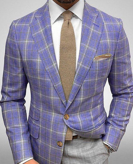 Blue plaid suit jacket with a brown tie and pocket square on a gray background