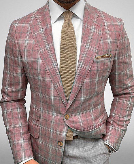 Pink plaid suit with a beige tie on a gray background