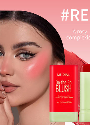 A cylindrical container of MEIDIAN On-the-Go Blush with a red label and green bottom, indicating a natural blusher product.