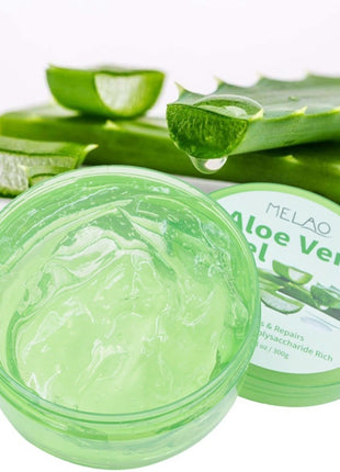 Aloe vera gel jar with fresh aloe leaves on a white background