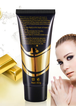 Gold and black skincare product tube with a woman's face on a white background