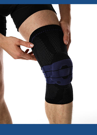 Person wearing a black knee brace on a white background