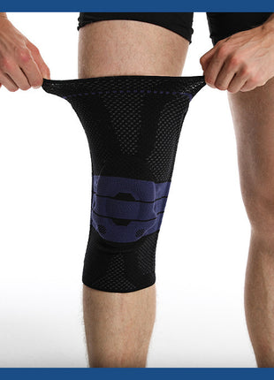 Person wearing a black knee brace on a white background