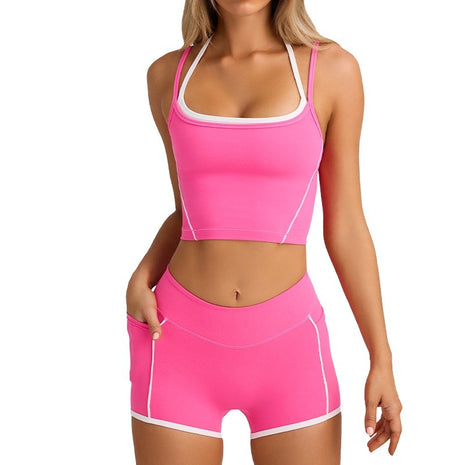 Woman wearing a pink athletic outfit with white trim on a white background