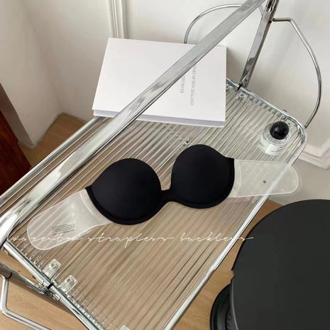 Black bra on a clear stand with a white background