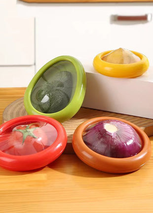 Four colorful kitchen containers with lids on a wooden surface.