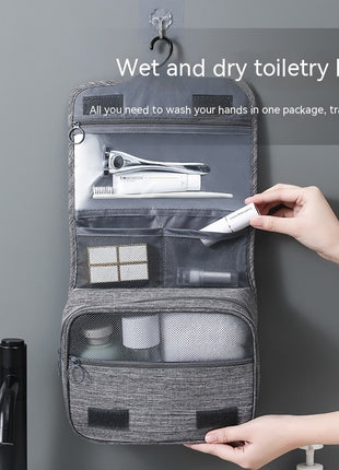 Gray toiletry bag with travel items on a gray background
