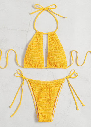Yellow bikini set on a light gray background