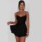Woman wearing a black dress against a plain background