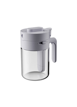 Clear glass pitcher with gray lid and handle on a white background
